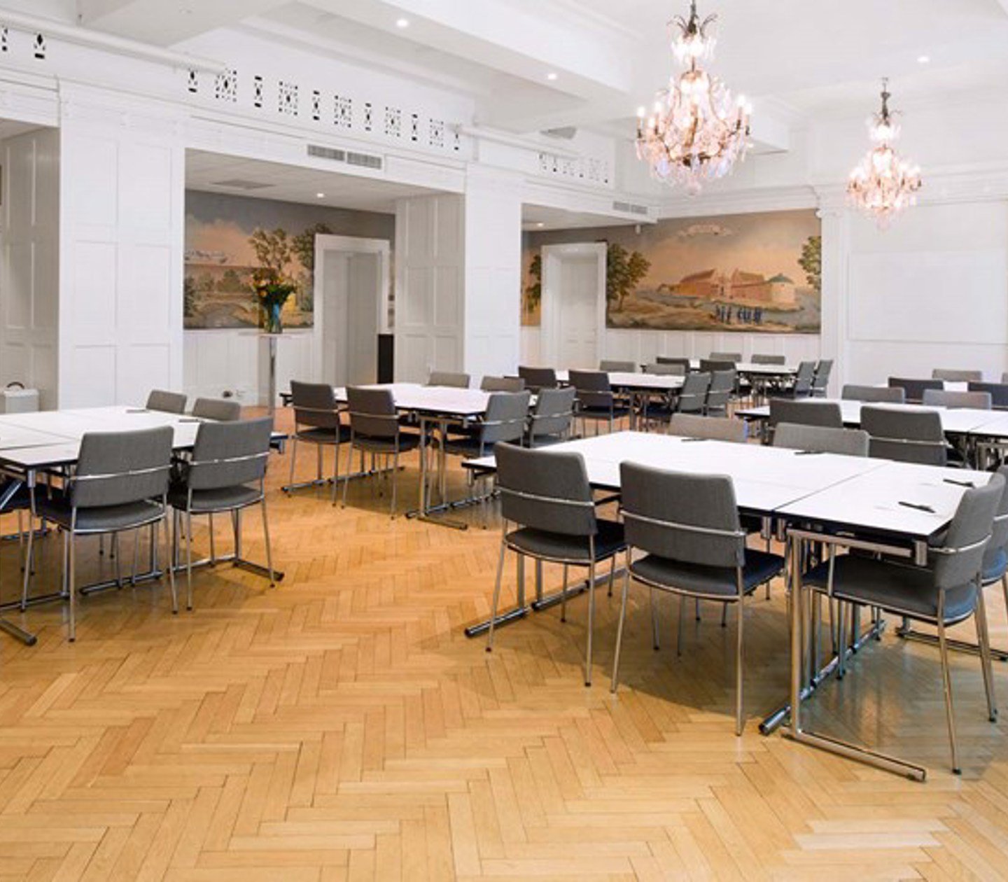 Conference room with crystal chandeliers on the ceiling prepared for meeting