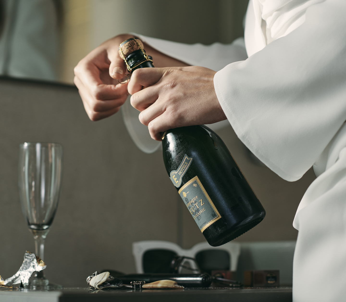 Waiter opens a bottle of champagne