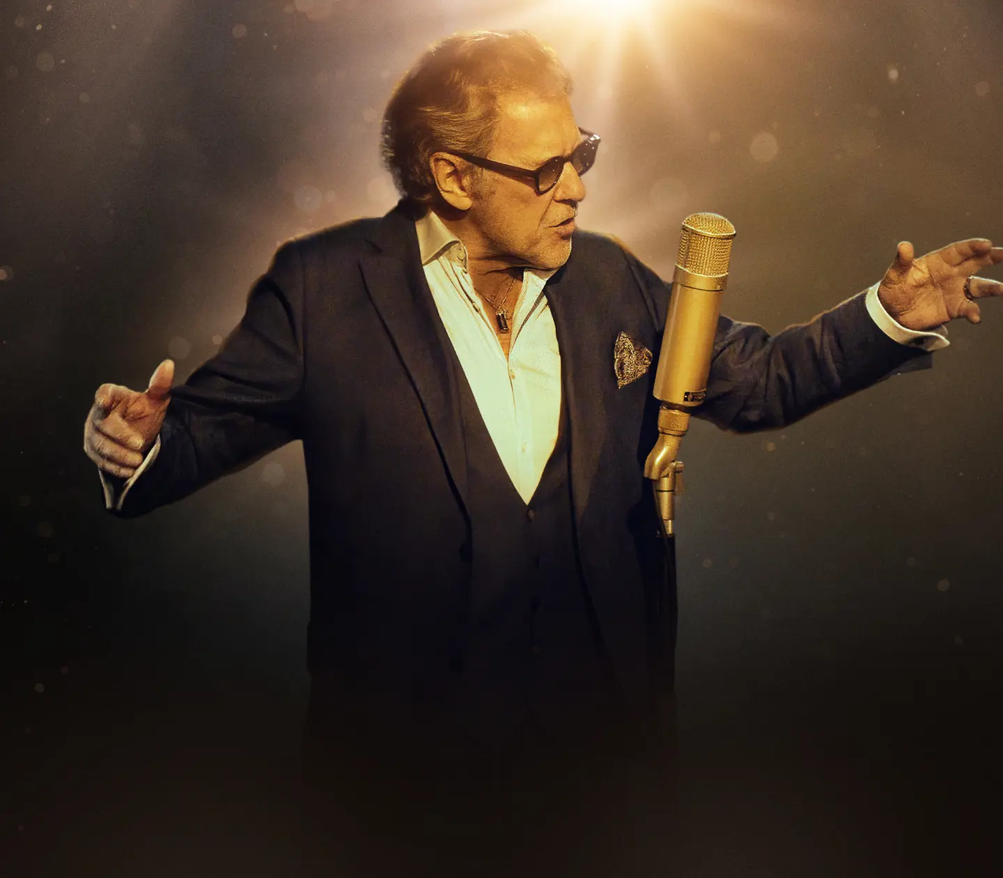 Elegant singer performing in spotlight with vintage microphone on stage, classic entertainment and live music concept.