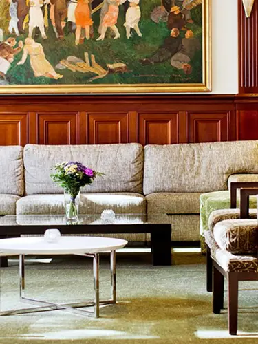 Sofa with chairs in lobby.