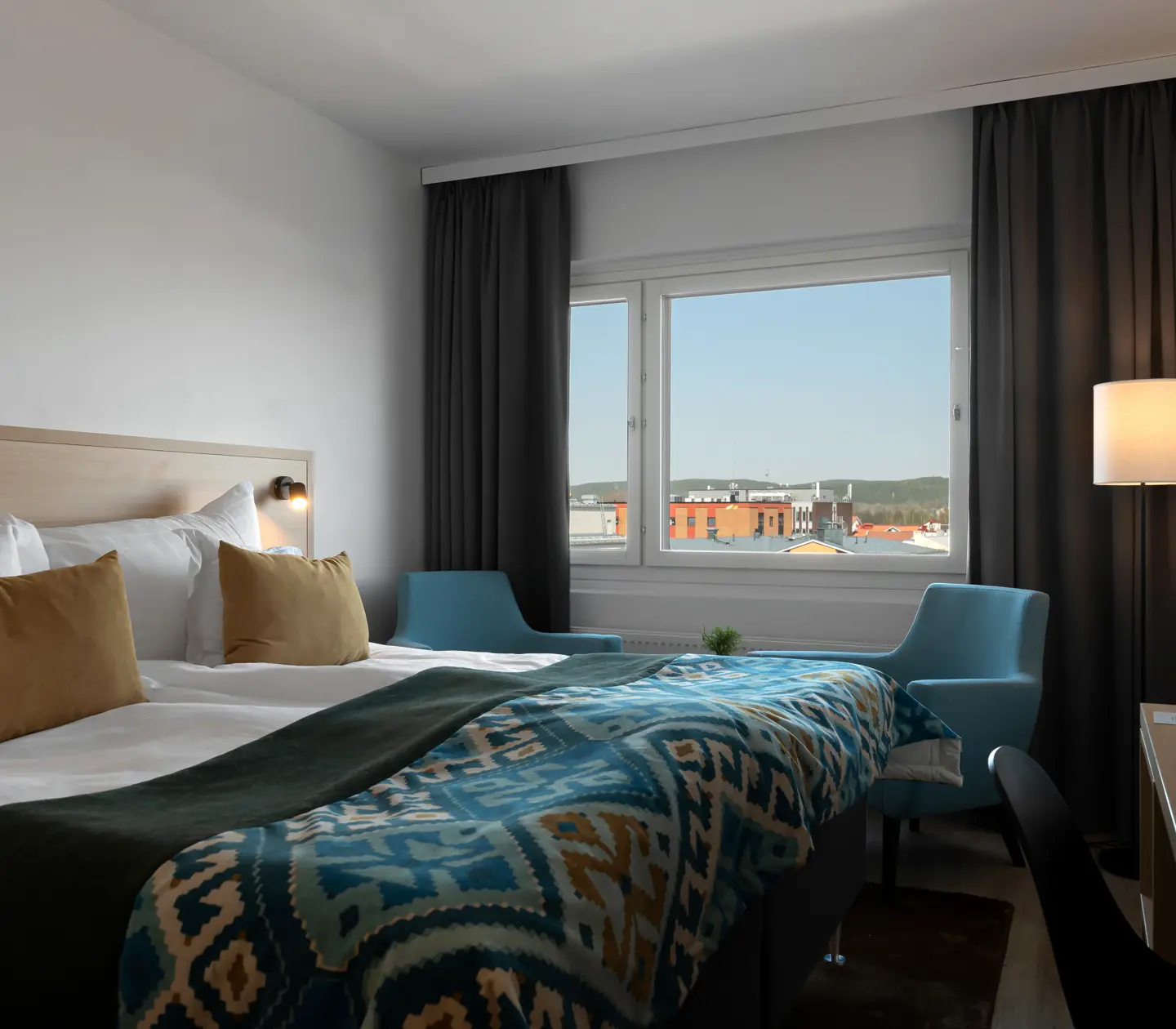 Hotel room with double bed, desk and window