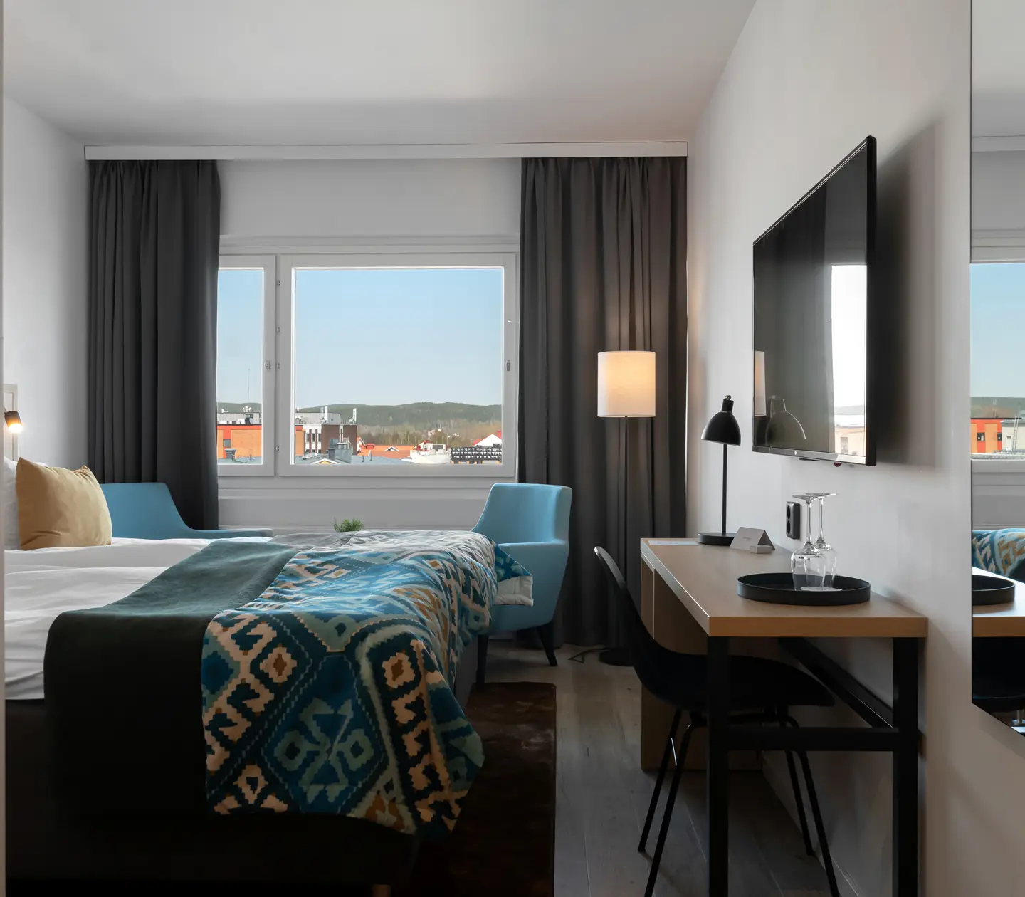 Hotel room with double bed, desk and window