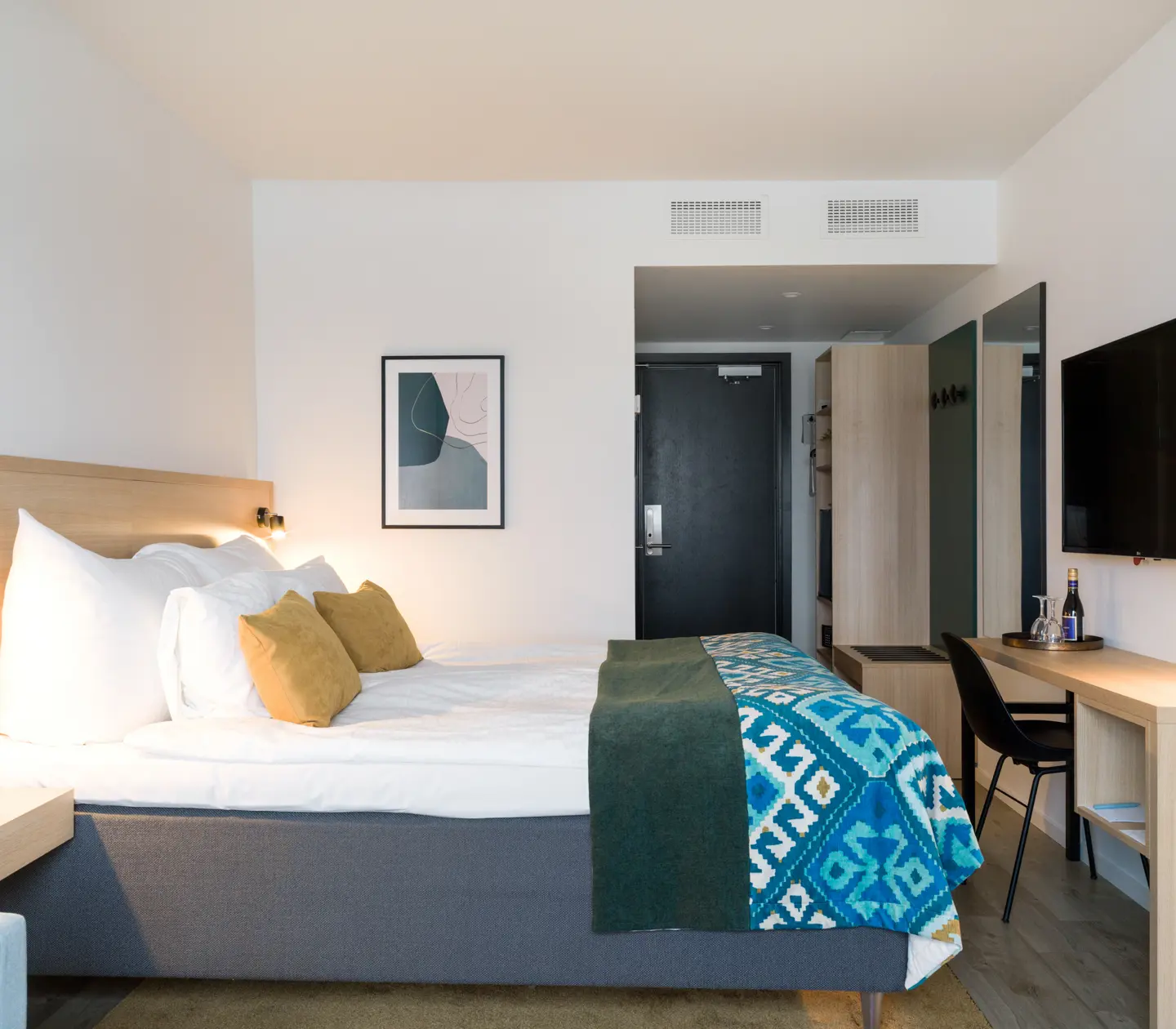 Hotel room with double bed and desk
