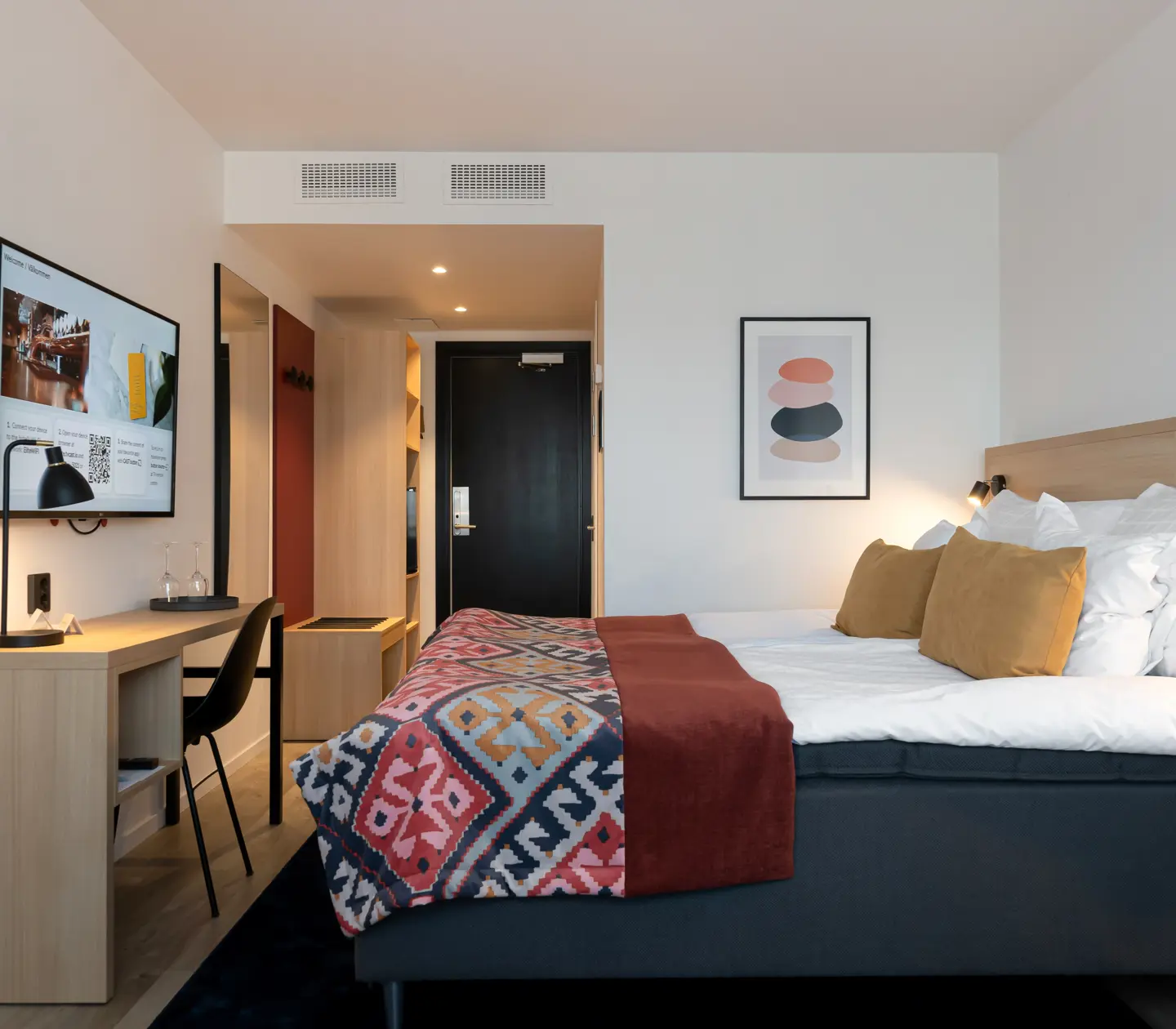 Hotel room with double bed and desk