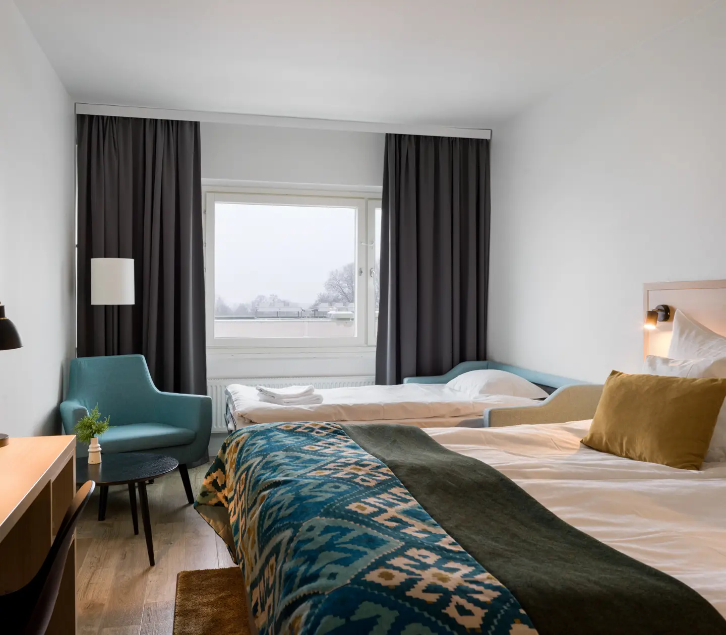 Hotel room with double bed and sofa bed