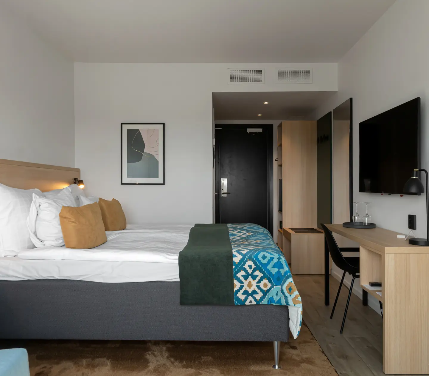 Hotel room with double bed and desk