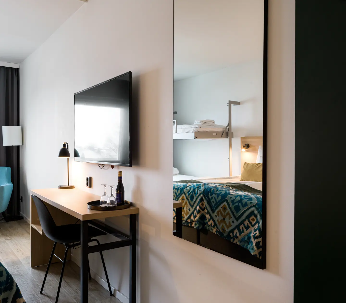 Hotel room with mirror, desk and TV