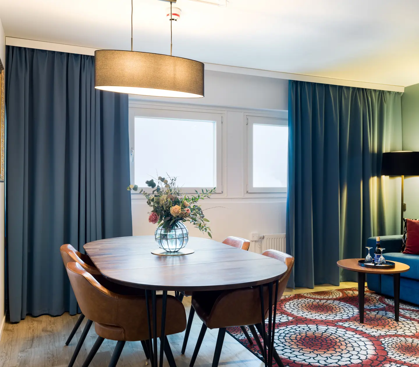 Suite with dining table, sofa and window