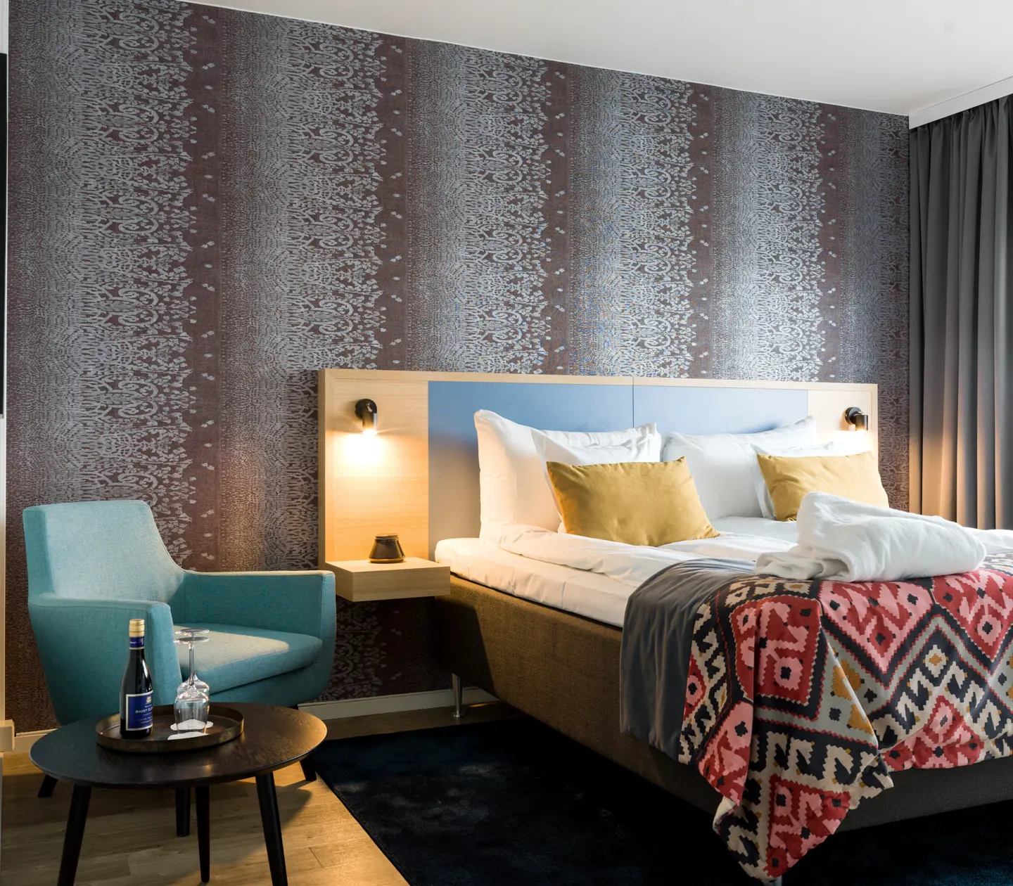 Hotel room with wallpaper and double bed