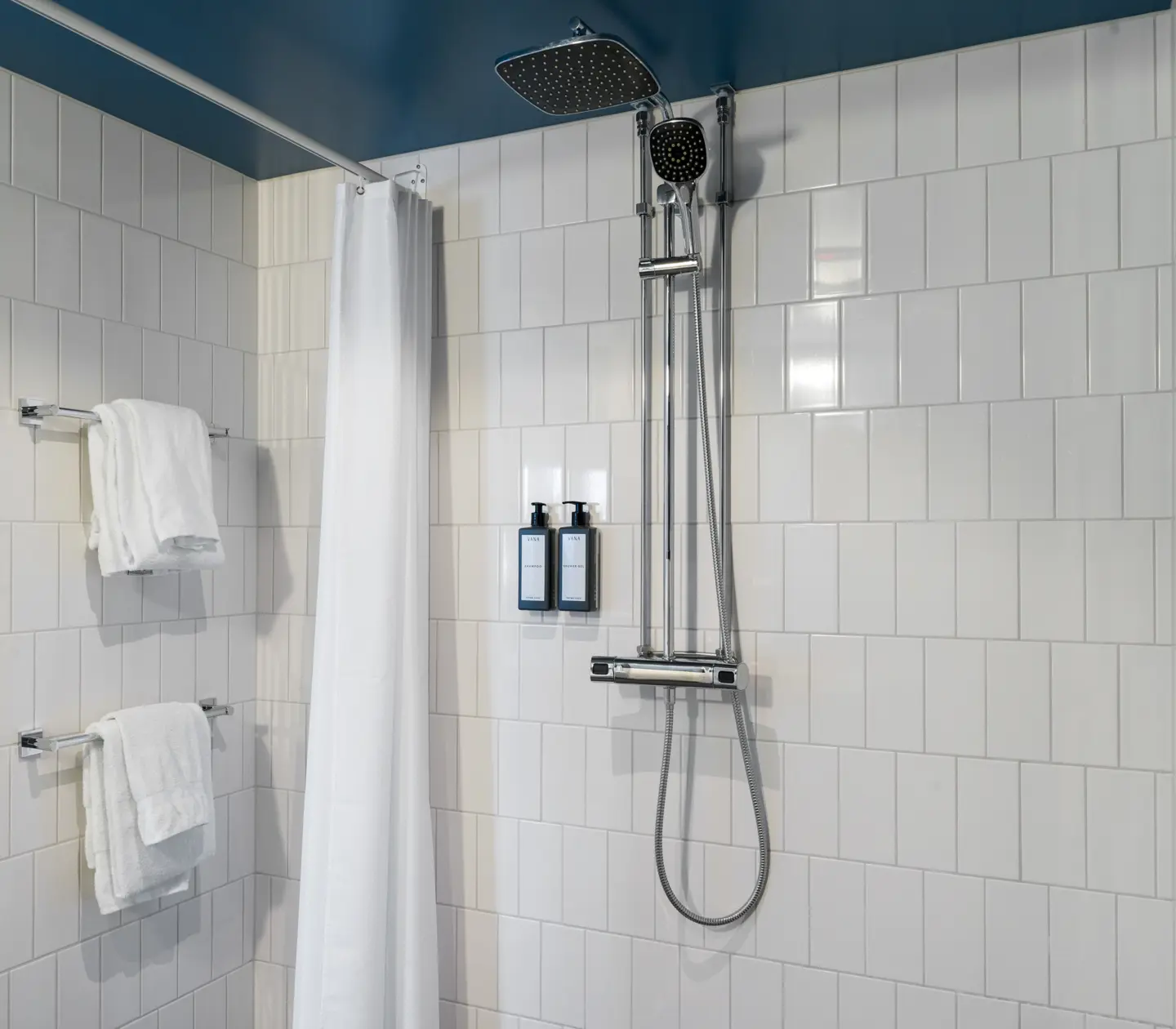 Bright bathroom with shower and towels
