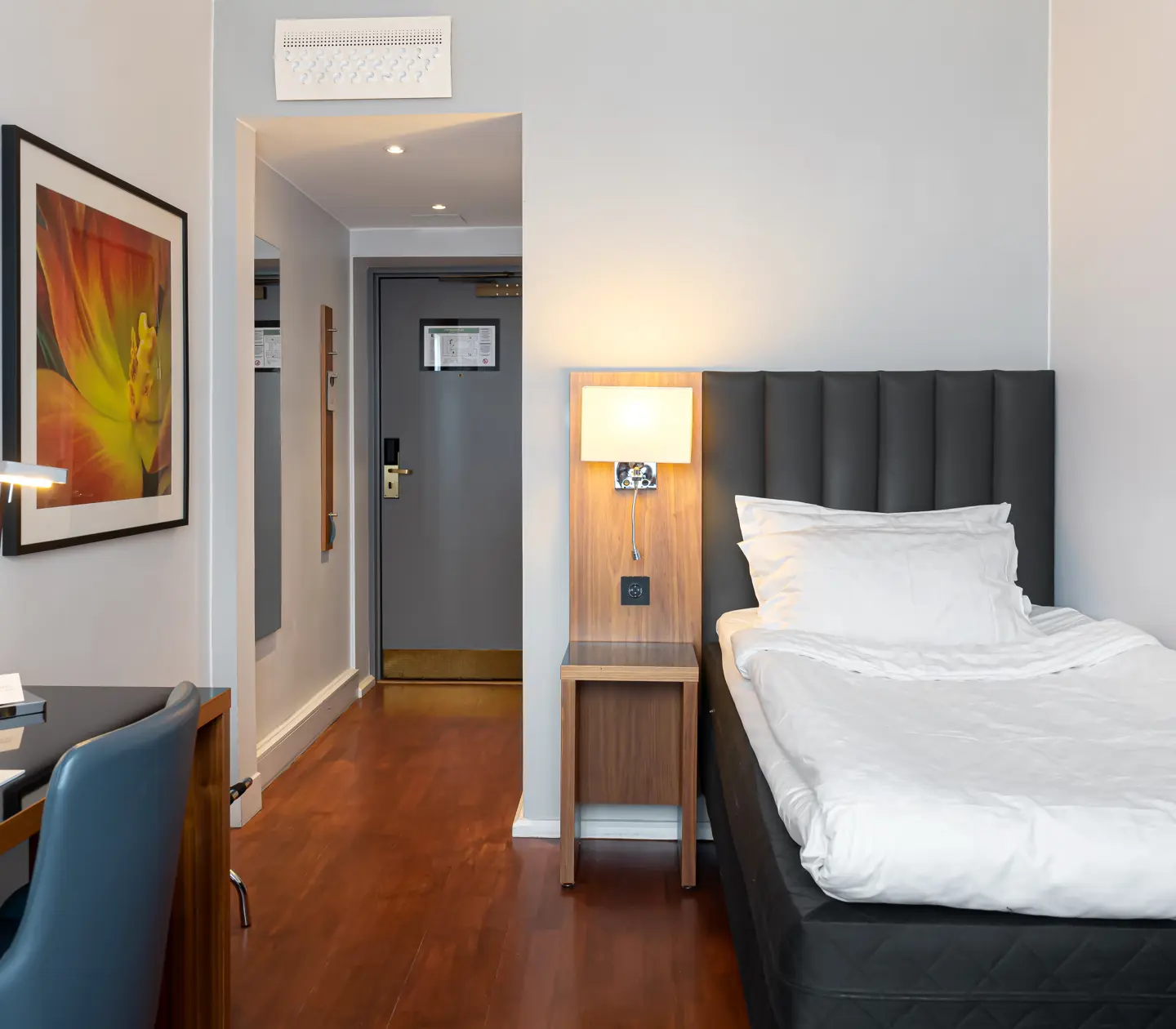 Hotel room with single bed and blackboard