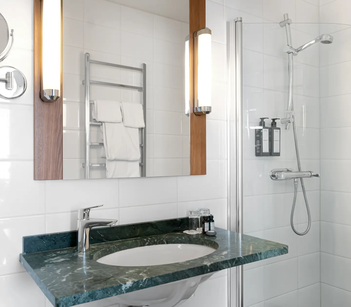 Bright bathroom with sink, shower and mirror