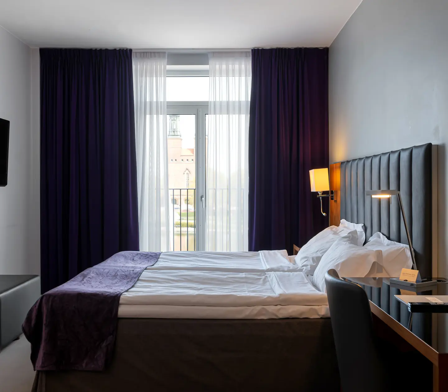 Hotel room with double bed, window and TV