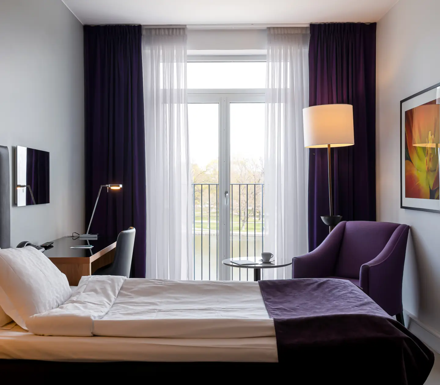 Hotel room with single bed, armchair and desk