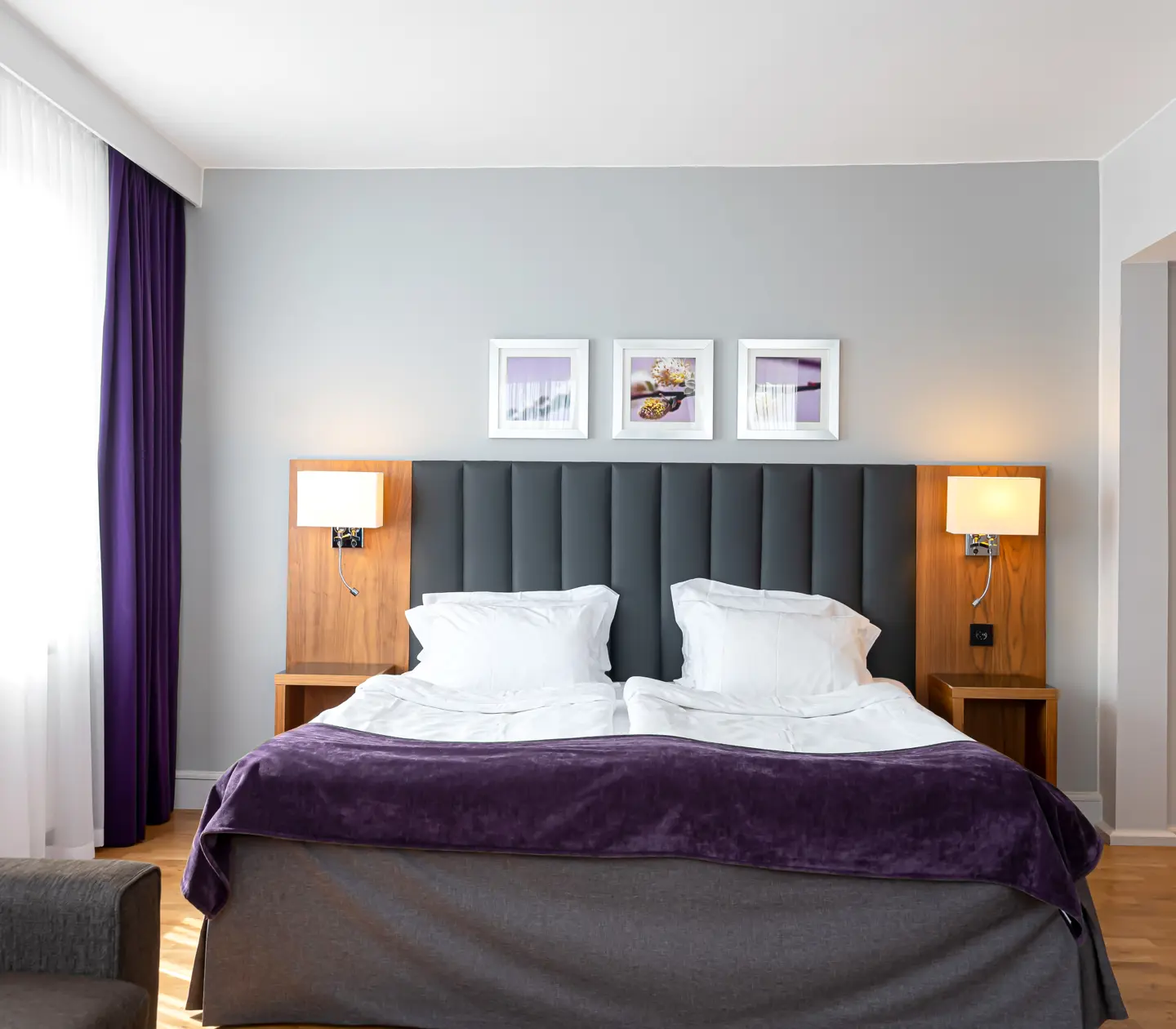 Hotel room with double bed and paintings
