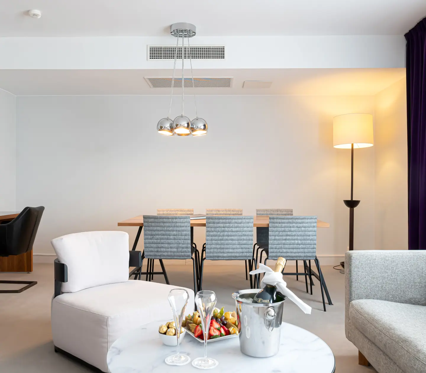 Suite with dining table, sofa and desk