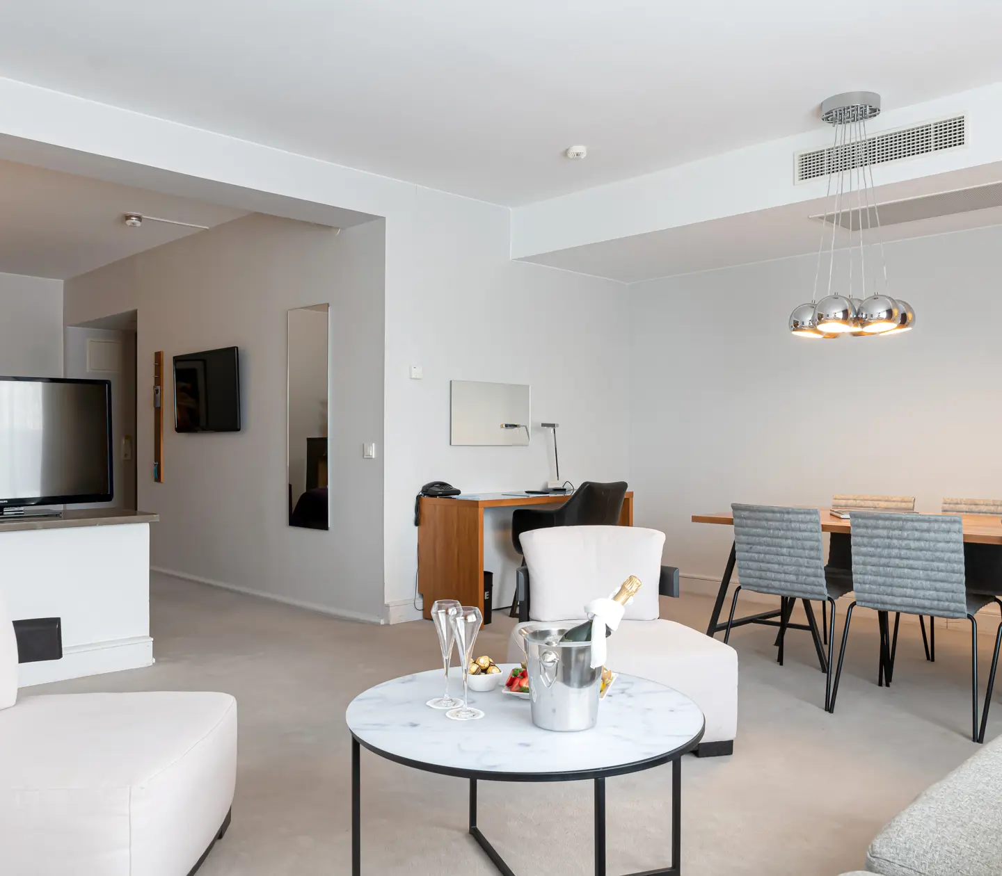 Suite with dining table, desk and TV