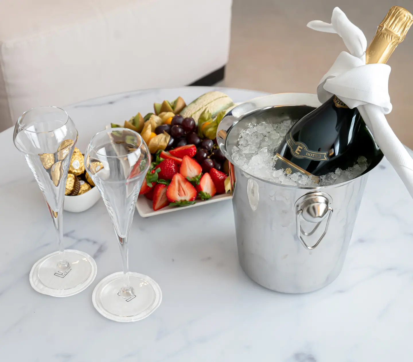 Vip laid out on the table with champagne, fruit and chocolate