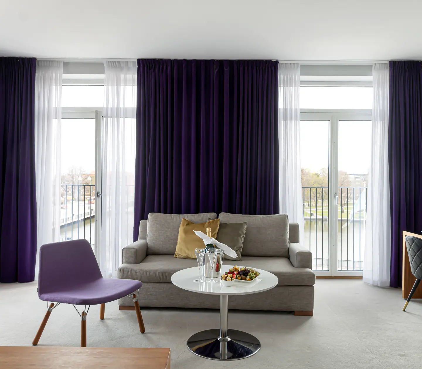 Suite with desk, sofa and large windows