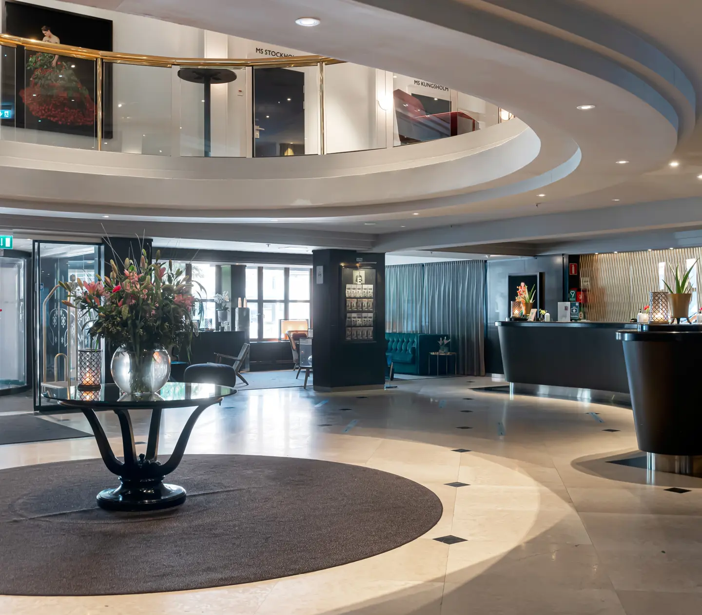 Hotel lobby with reception desks and open roof