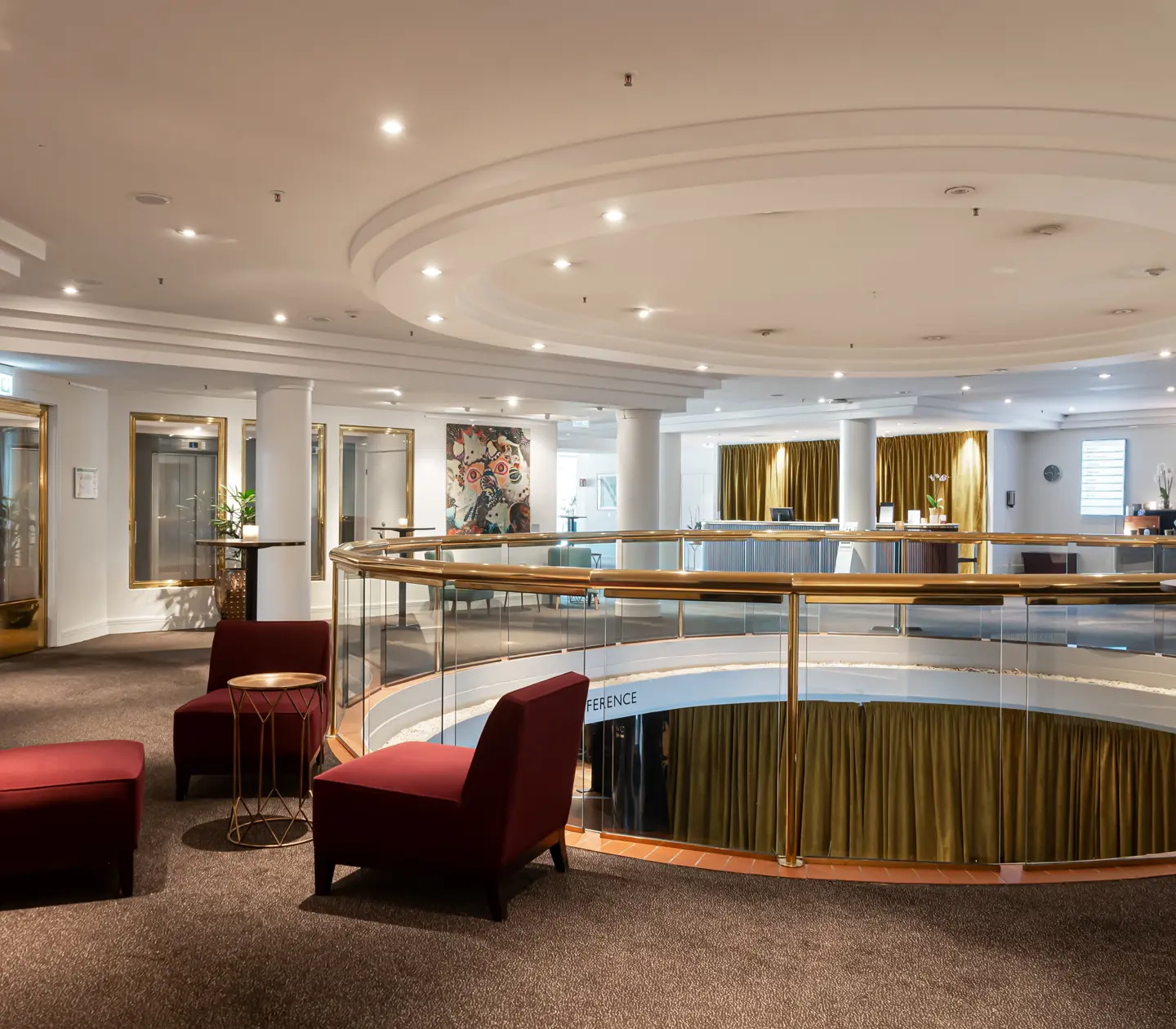 Hotel environment with opening down to the lower floor and seating areas