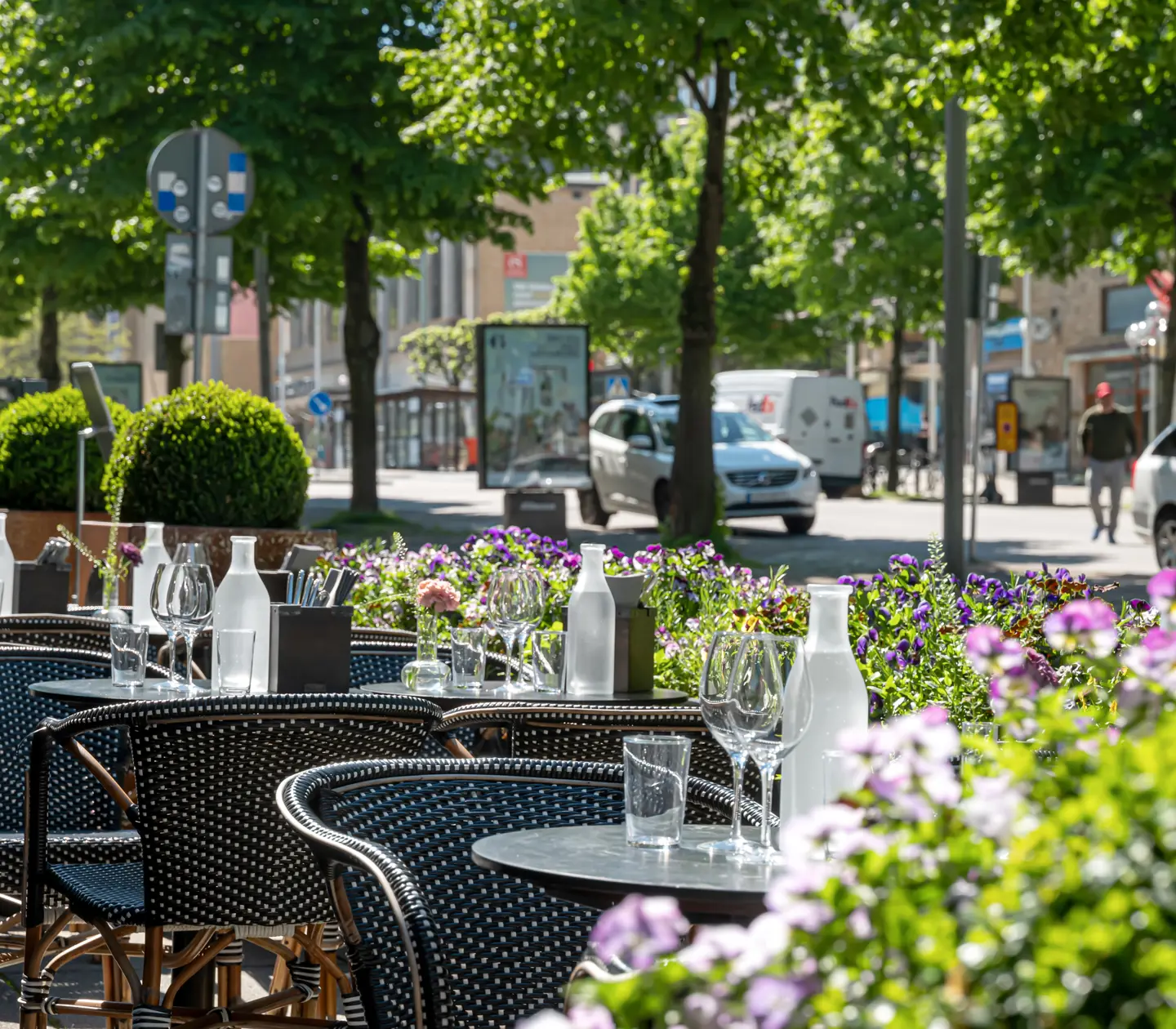 Outdoor seating with dining areas and street outside