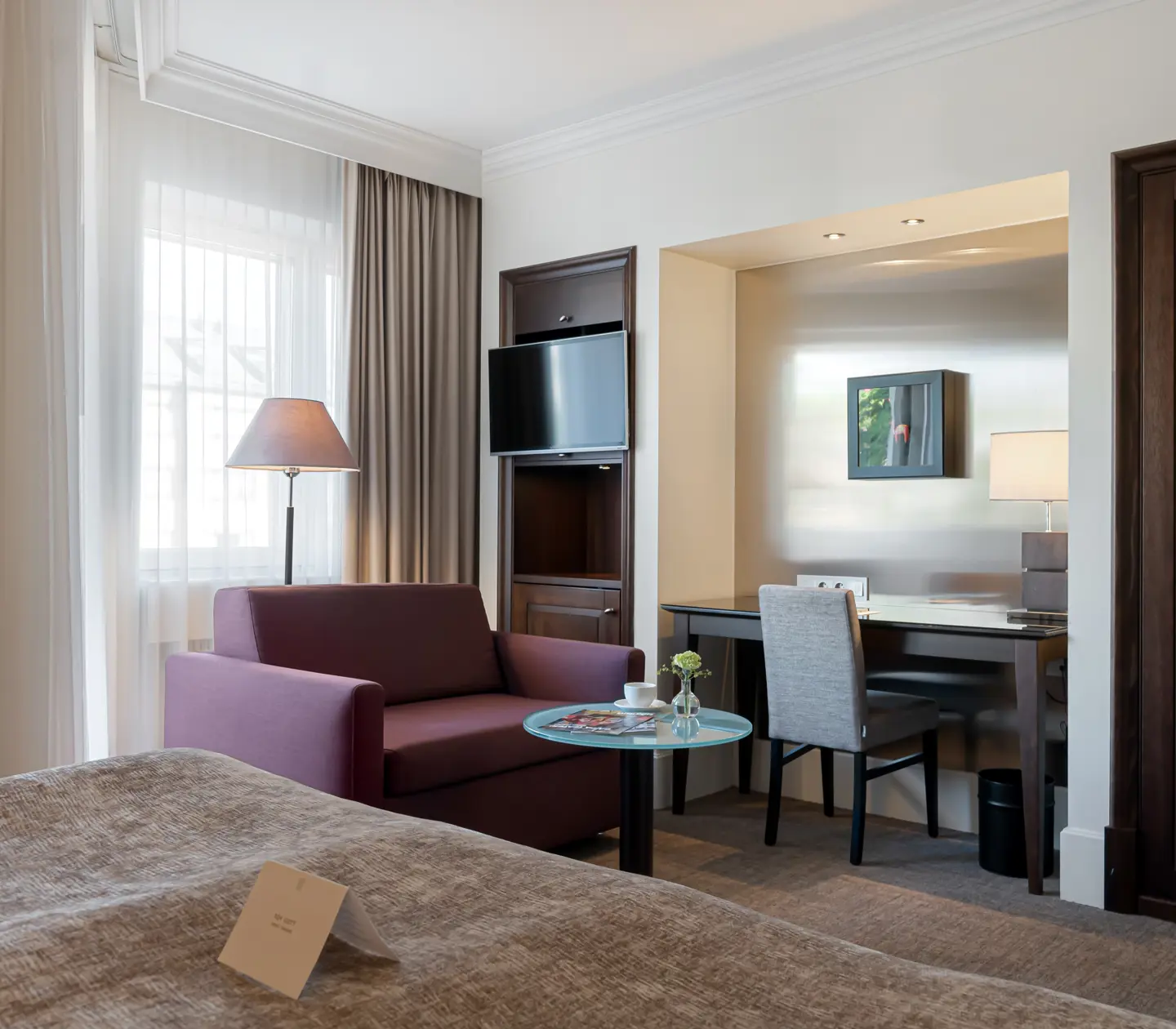 Hotel room with sofa, desk and TV