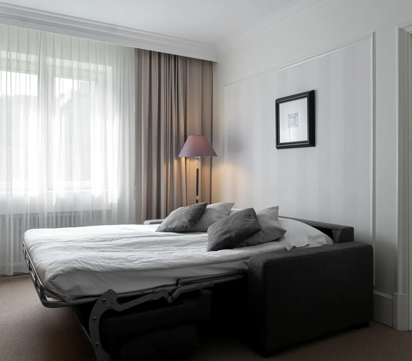 Hotel room with double bed and sofa bed