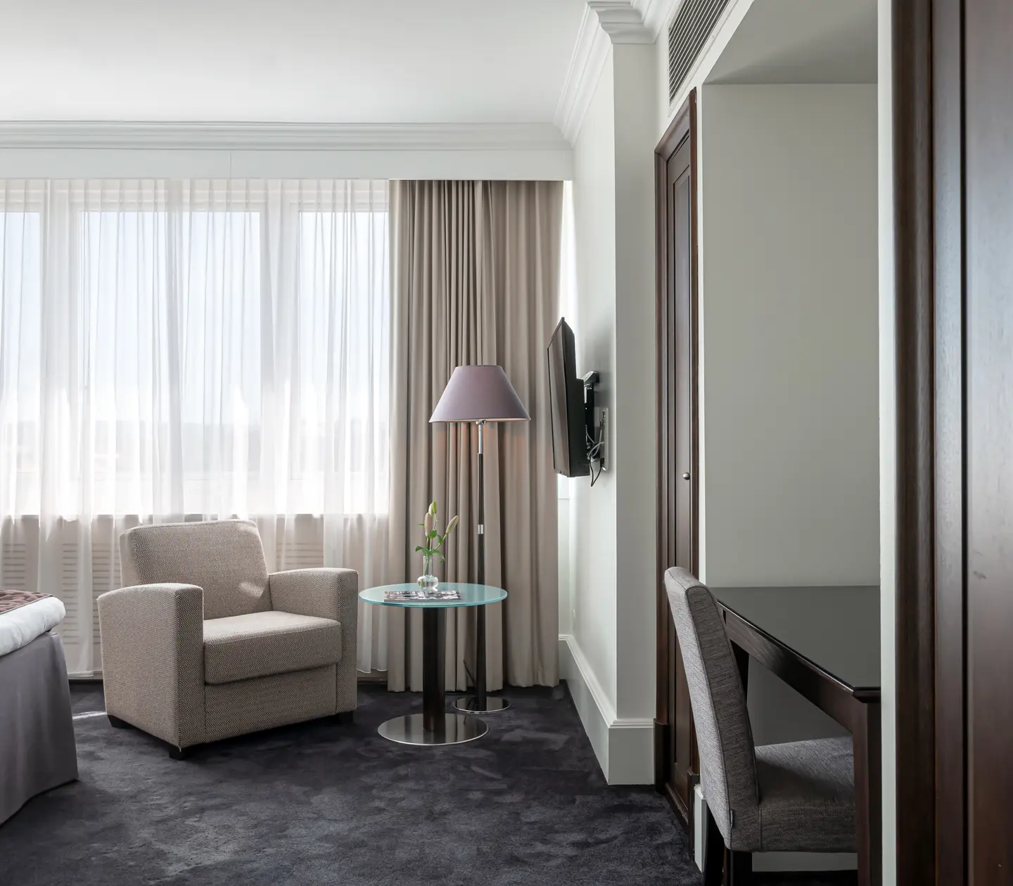 Suite with desk, armchair and many windows