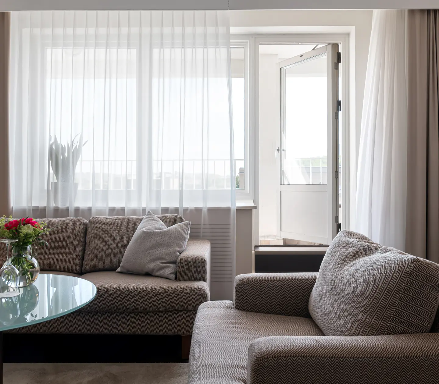 Suite with sofa, armchair and balcony door