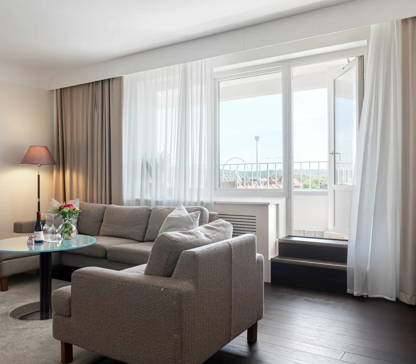 Suite with large sofa and balcony door
