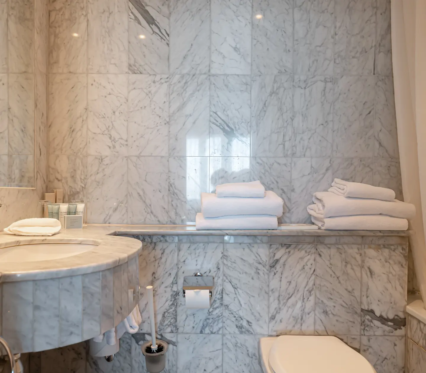 Bright bathroom with sink and towels