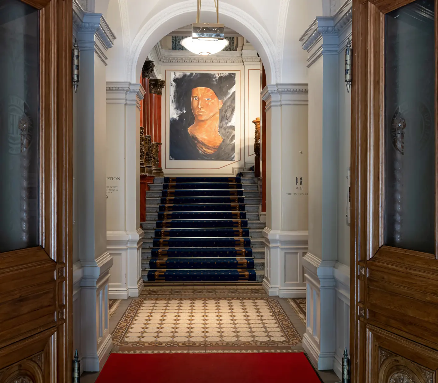 Hotel environment with stairs and painting of a face