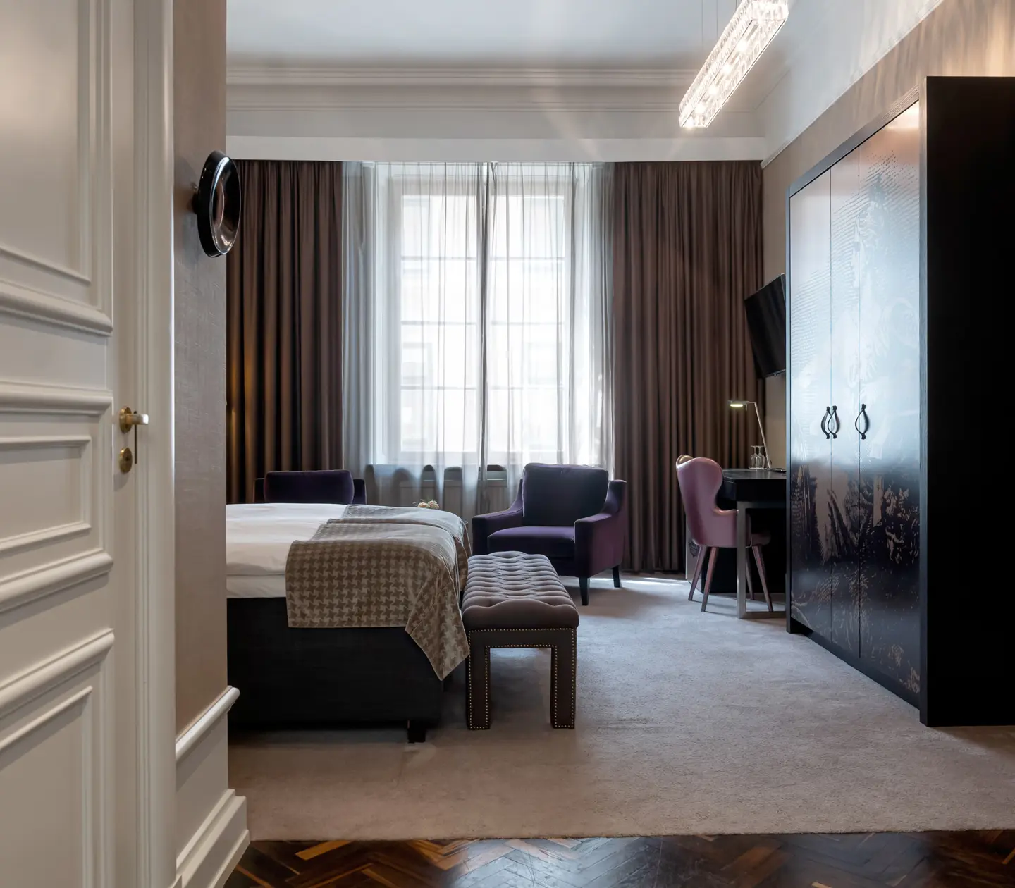 Hotel room with bed, wardrobes and desk