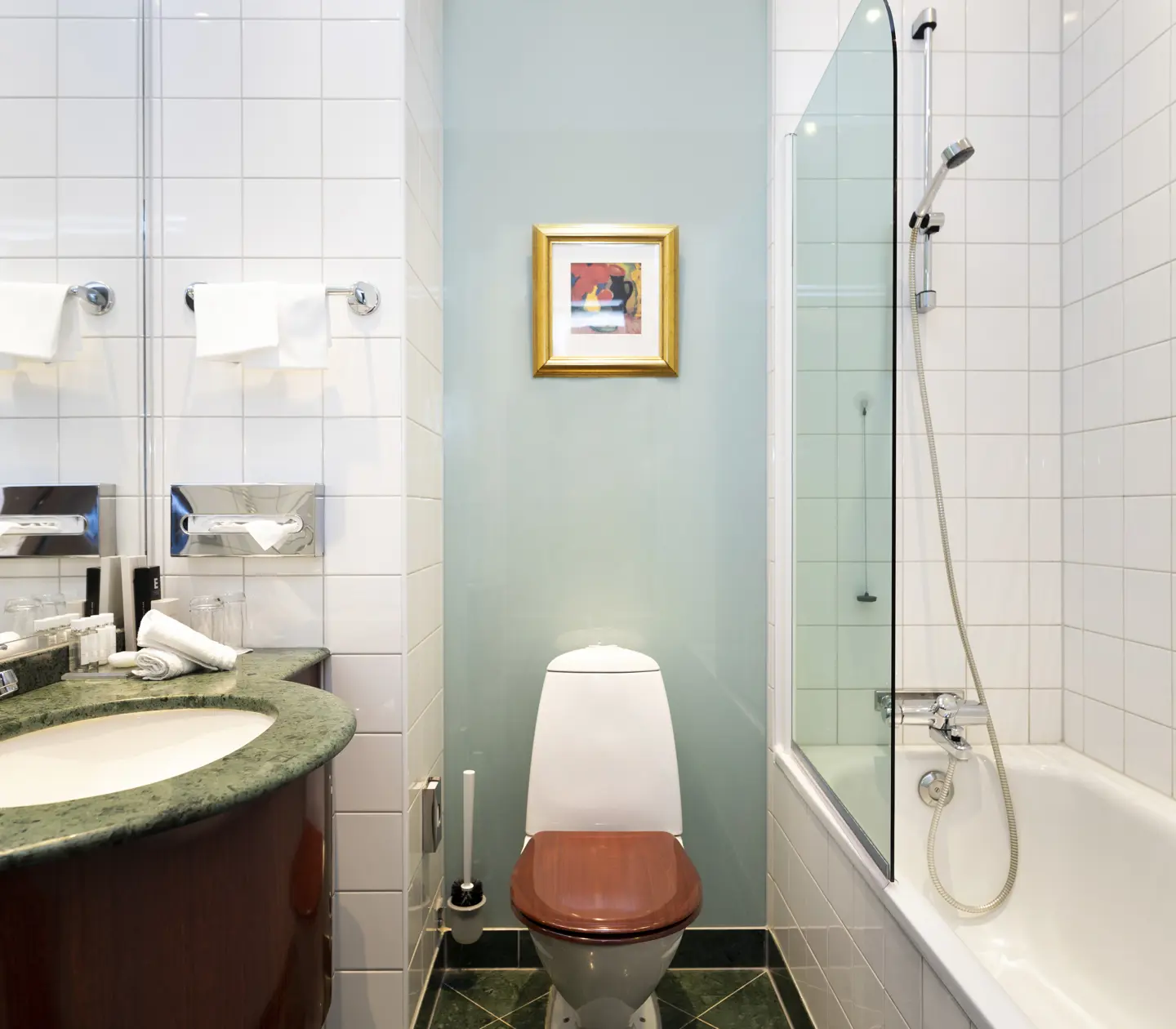 Bright bathroom with bathtub, toilet and sink