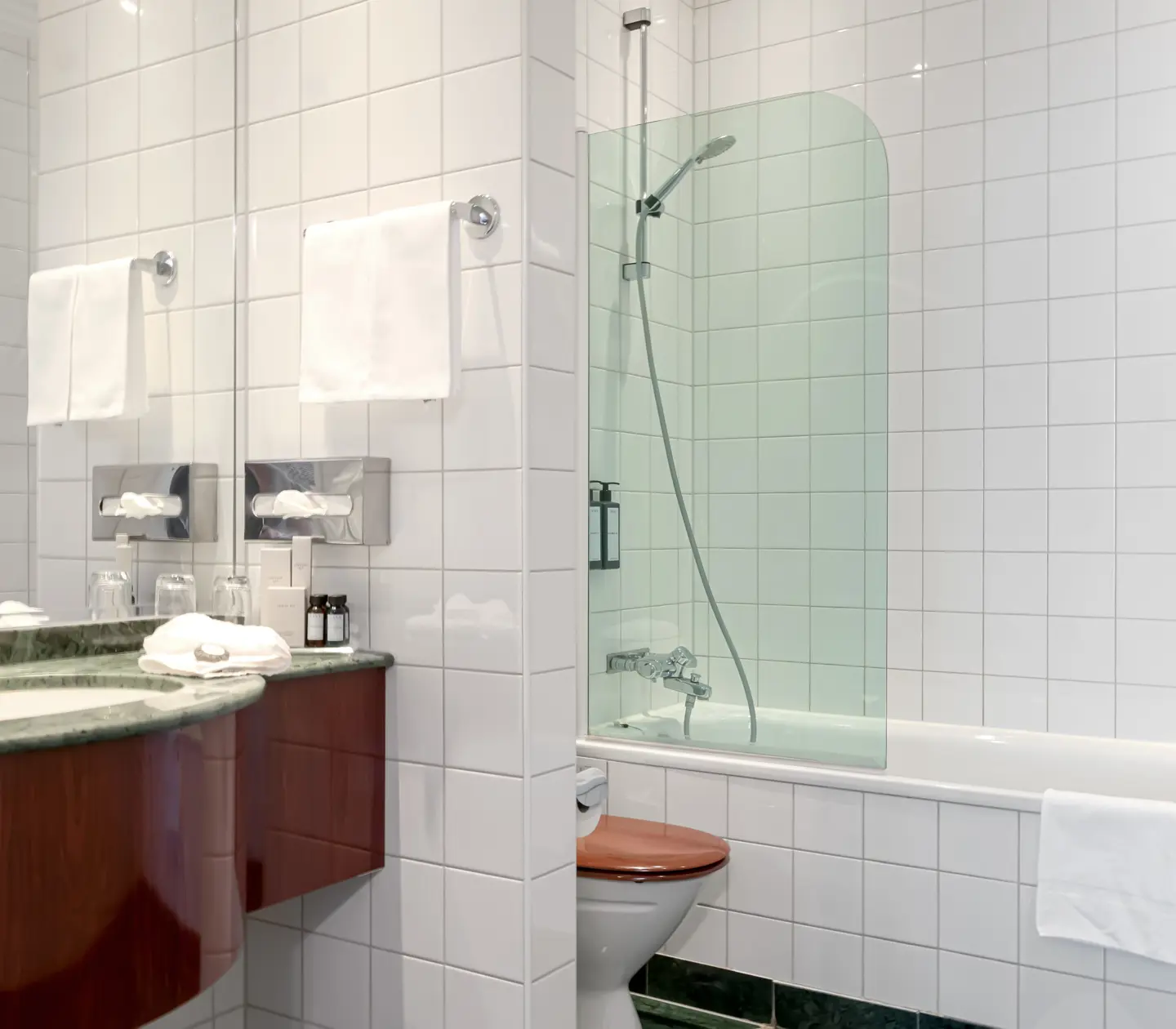 Bright bathroom with bathtub, toilet and sink
