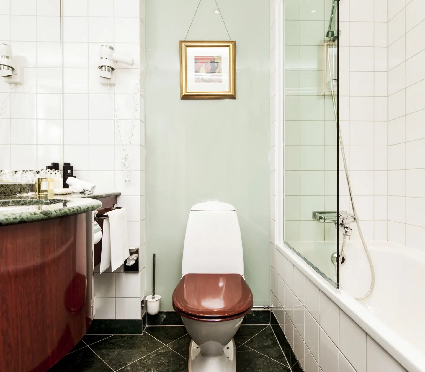 Bright bathroom with bathtub, toilet and sink