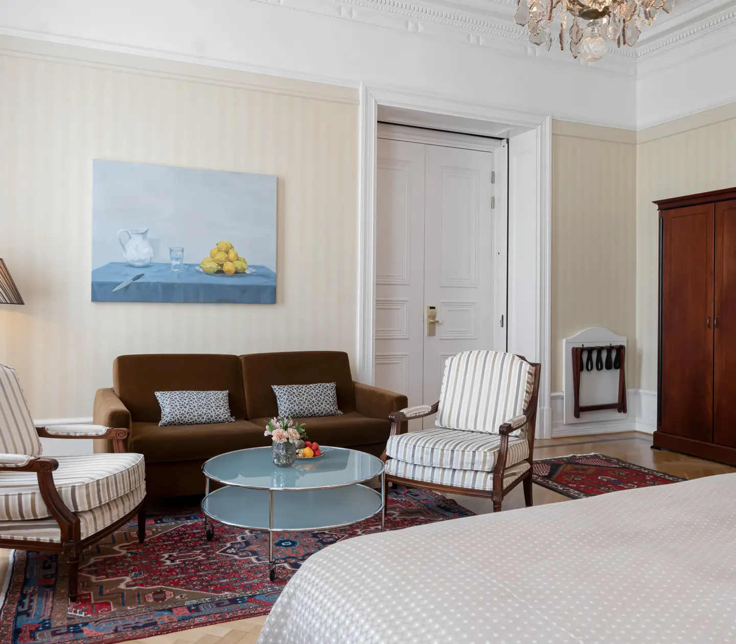 Charming hotel room with wardrobe, sofa group and painting