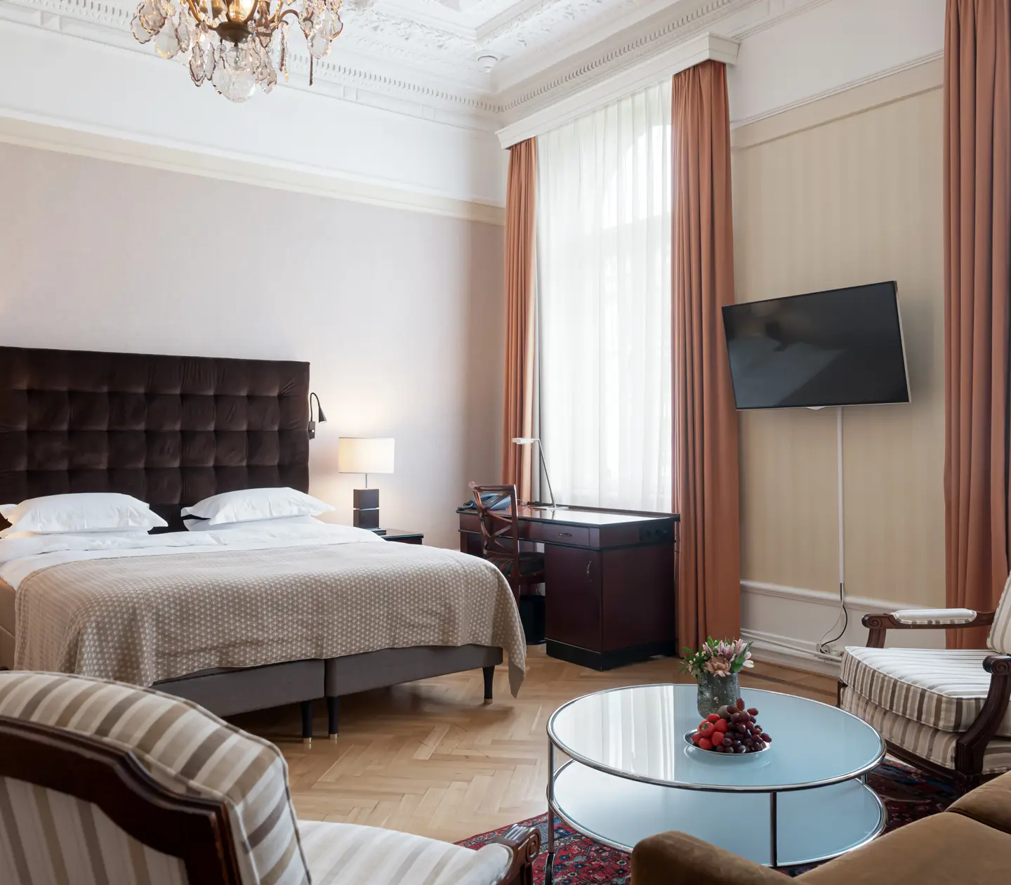 Charming hotel room with bed, large windows and desk