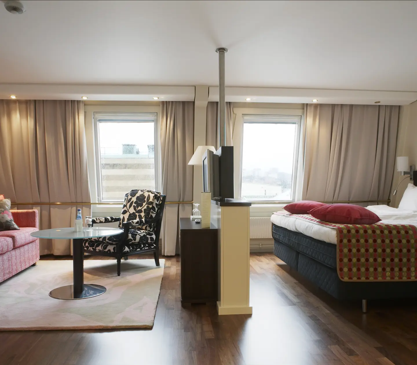 Hotel room with bed, sofa group and window