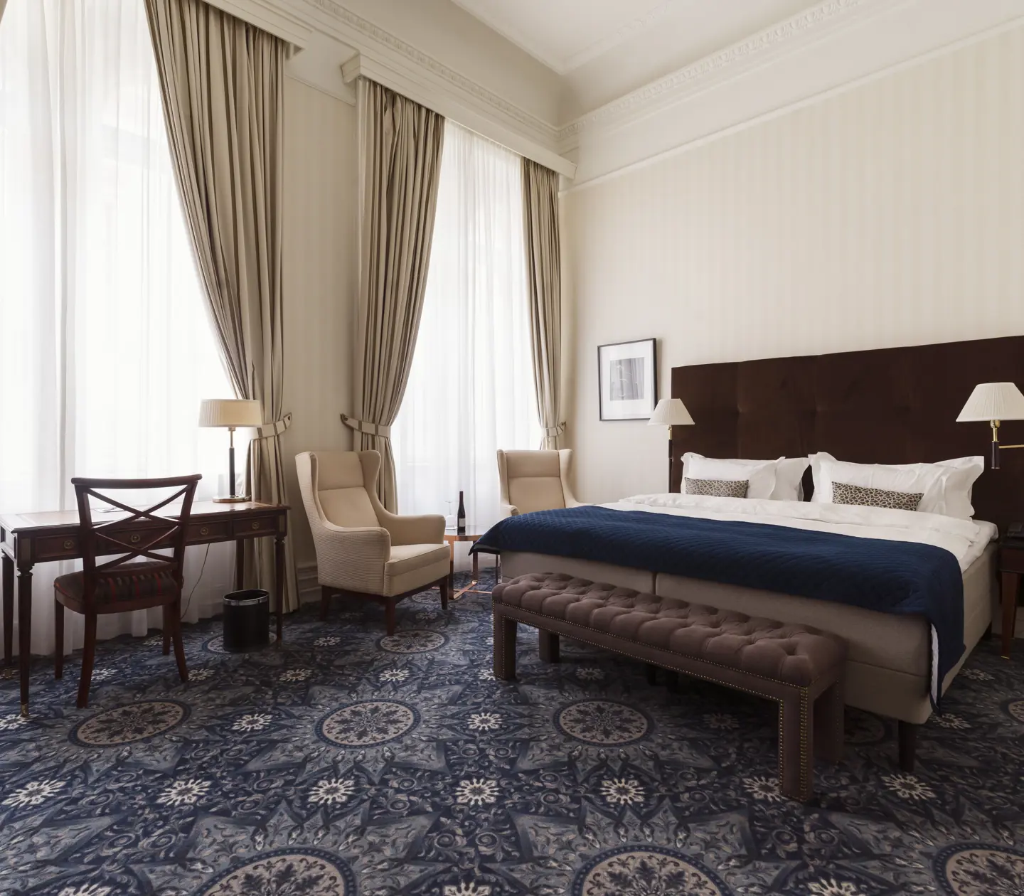 Cozy suite with wall-to-wall carpet, double bed, and window.