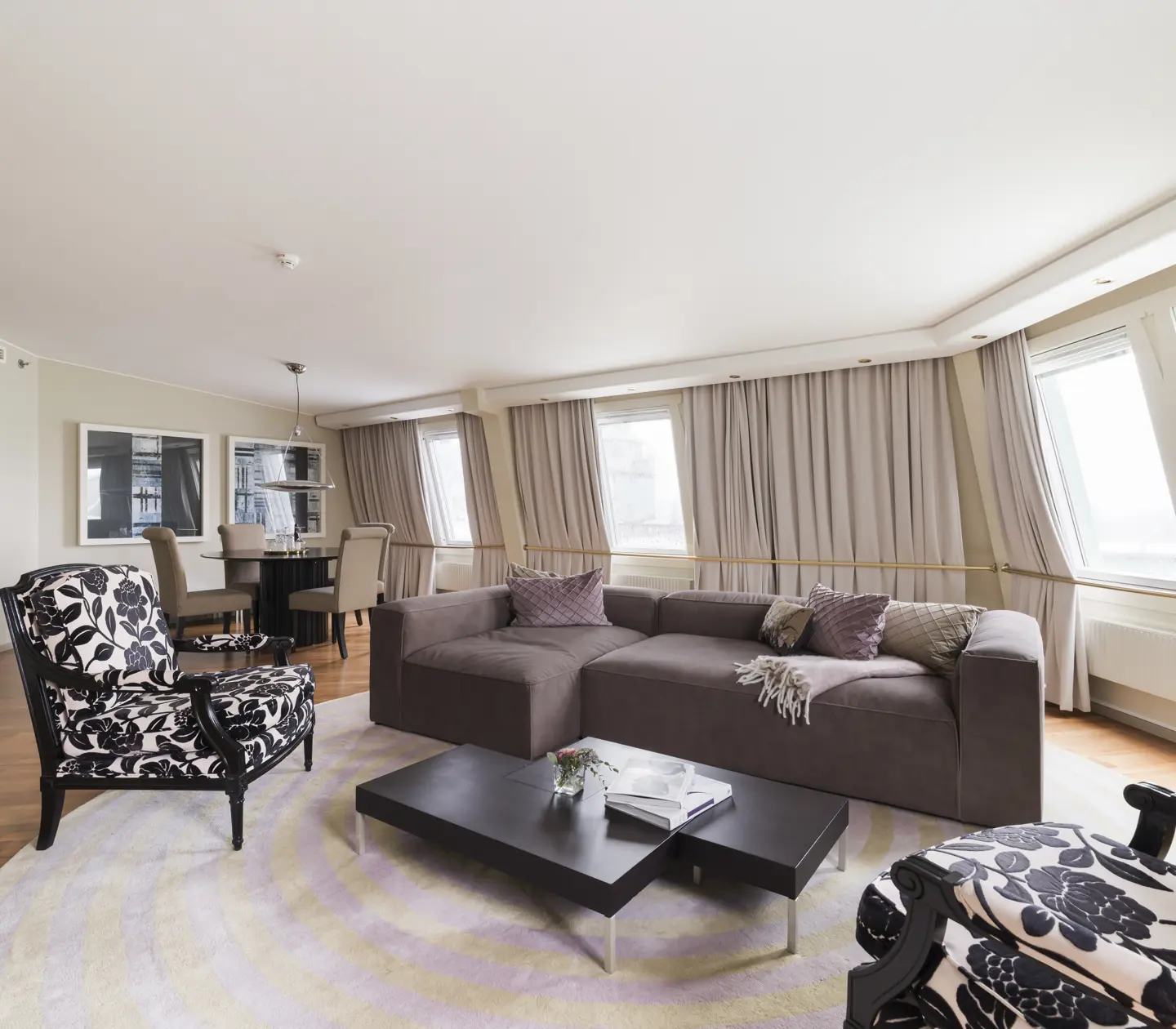 Cozy suite with seating area, dining area, and many windows