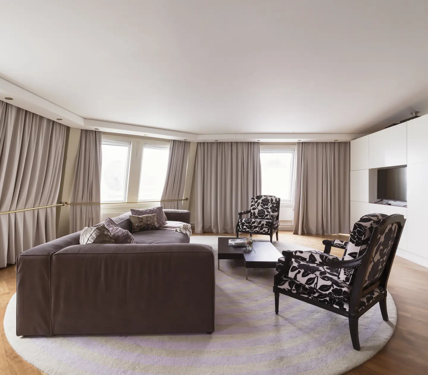 Cozy suite with seating area, window, and TV