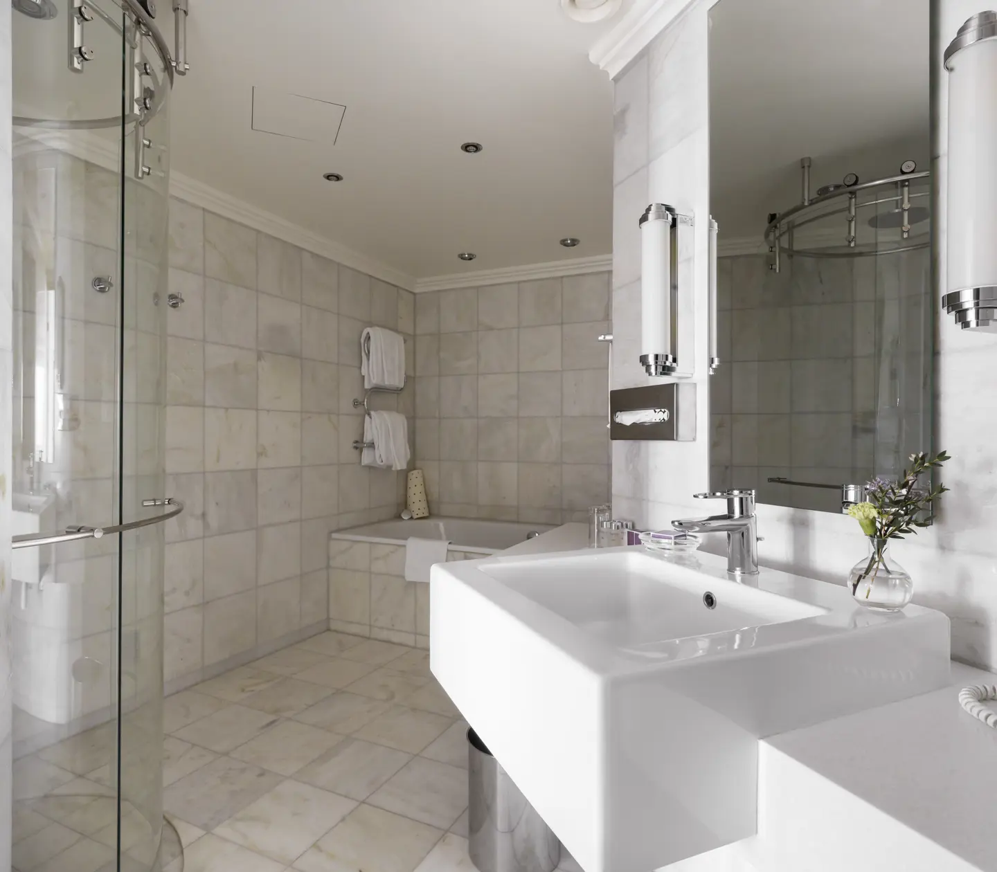 Bright bathroom with sink, bathtub, and shower.