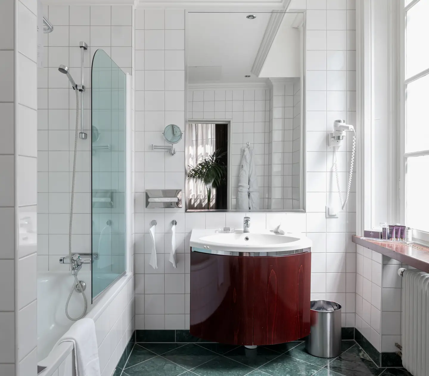 Bright bathroom with bathtub, window and sink