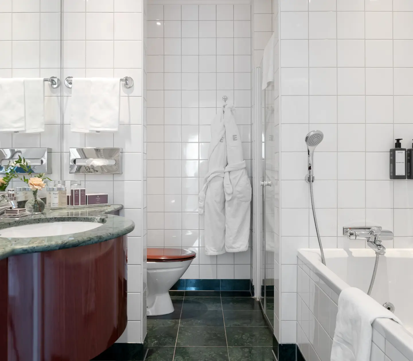 Bright bathroom with bathtub, toilet and sink