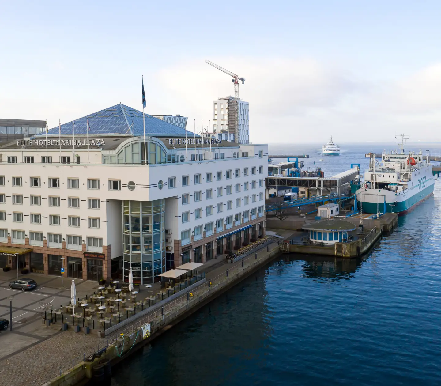 The white facade of the Elite Hotel Marina Plaza with Helsingborg's harbor in front