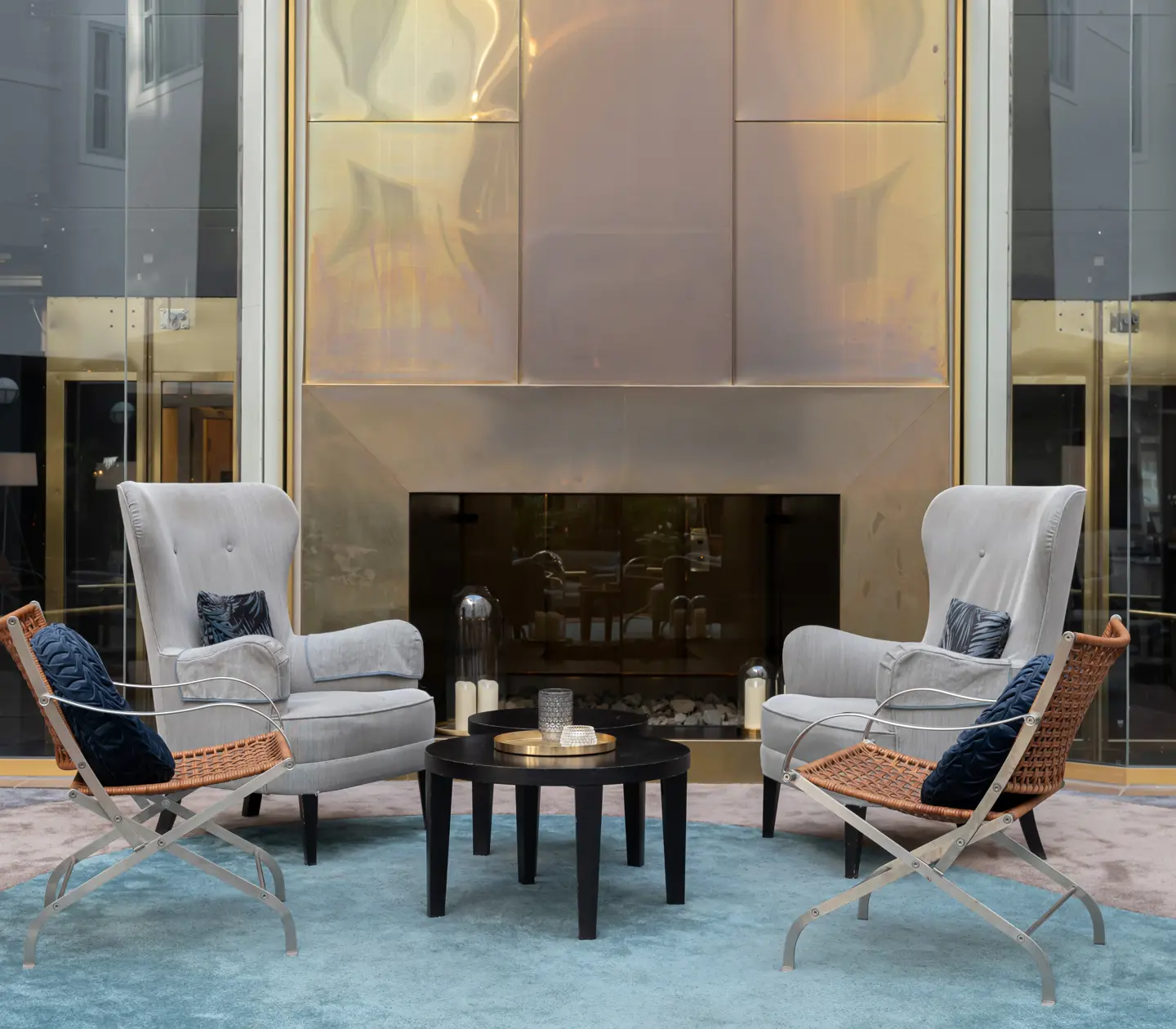 Cozy hotel lobby with seating area and tiled stove