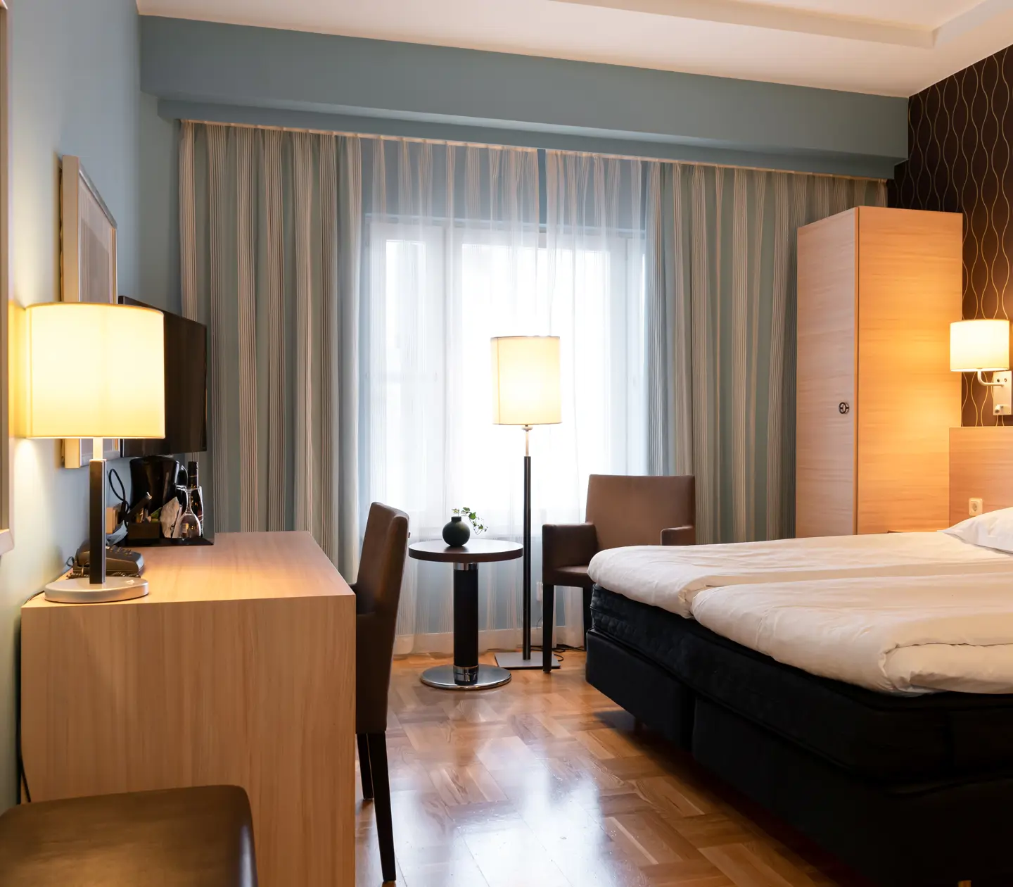 Cozy hotel room with bed, desk and window