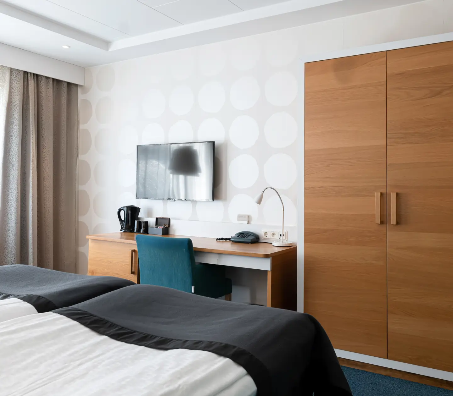 Hotel room with desk, wardrobe and television
